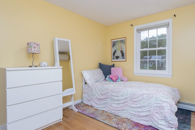 27 Grafton Dr, Bedford, NH 03110 - bedroom featuring wood finished floors, a baseboard radiator, and baseboards