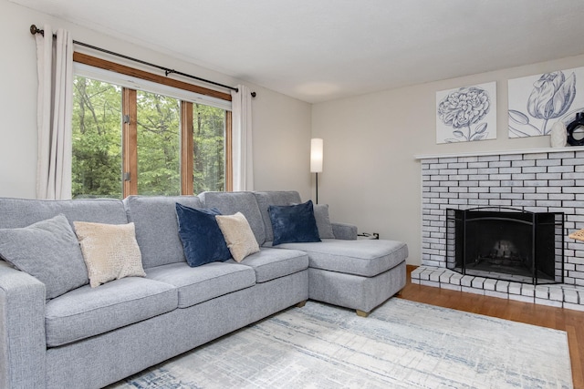 27 Grafton Dr, Bedford, NH 03110 - living area with wood finished floors and a brick fireplace