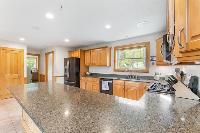 174 Sky View Rd, Stratford, NH 03590 - kitchen featuring stainless steel appliances, a sink, a peninsula, dark stone counters, and recessed lighting