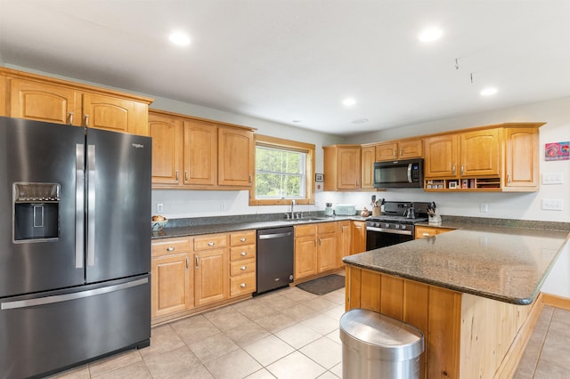174 Sky View Rd, Stratford, NH 03590 - kitchen with stainless steel appliances, a peninsula, dark stone countertops, light tile patterned floors, and recessed lighting