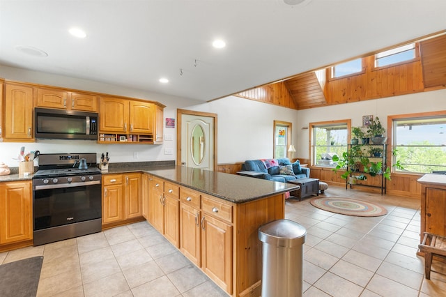 174 Sky View Rd, Stratford, NH 03590 - kitchen featuring stainless steel appliances, a peninsula, dark stone countertops, light tile patterned floors, and recessed lighting