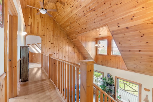 174 Sky View Rd, Stratford, NH 03590 - corridor with wood ceiling, an upstairs landing, wooden walls, a chandelier, and wood finished floors