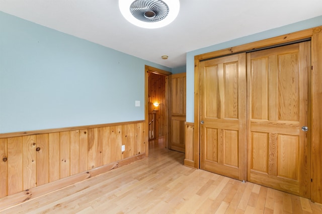 174 Sky View Rd, Stratford, NH 03590 - unfurnished bedroom featuring wainscoting, wood finished floors, and wood walls