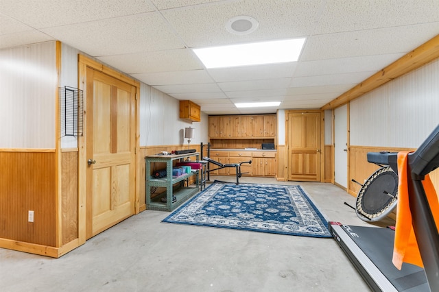 174 Sky View Rd, Stratford, NH 03590 - playroom with concrete floors, a paneled ceiling, and wooden walls