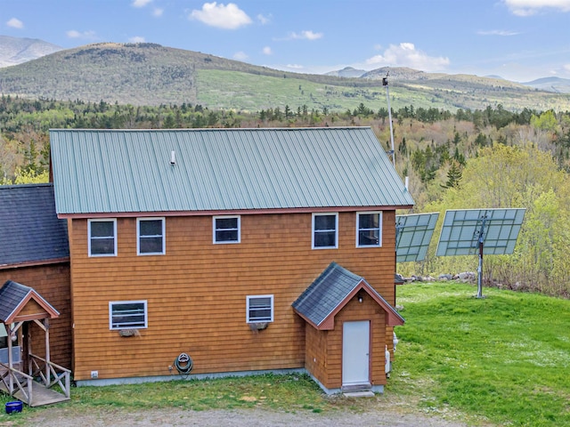 174 Sky View Rd, Stratford, NH 03590 - back of house featuring a mountain view, metal roof, and a lawn