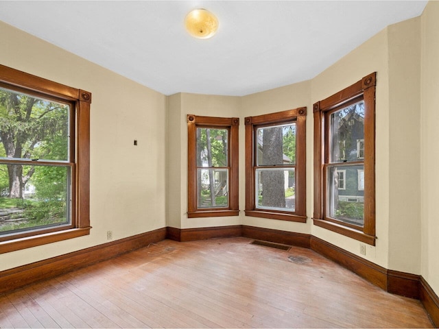 27 Ridge St, Montpelier, VT 05602 - spare room with wood-type flooring, plenty of natural light, and baseboards