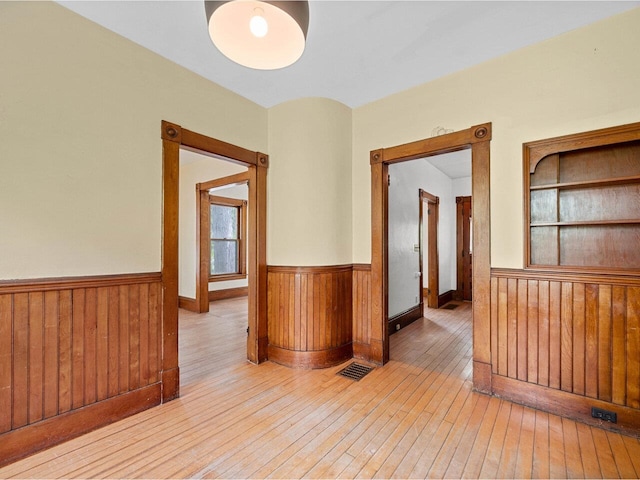 27 Ridge St, Montpelier, VT 05602 - spare room with wainscoting, wood-type flooring, and wooden walls