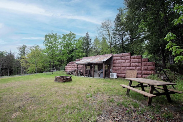 364 Spaulding Rd, Saint Johnsbury, VT 05819 - view of grassy yard with a fire pit, a cooling unit, an outbuilding, and exterior structure