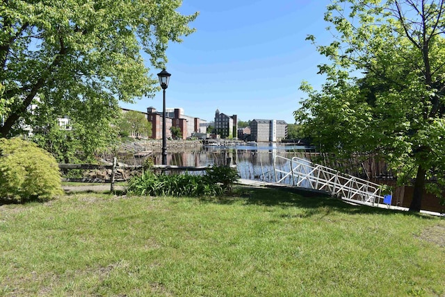 11 Creighton St, Newmarket, NH 03857 - view of grassy yard with a dock and a water view