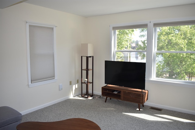 11 Creighton St, Newmarket, NH 03857 - carpeted living area with healthy amount of natural light and baseboards