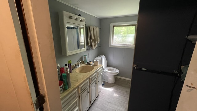 564 66th Rte, Randolph, VT 05060 - half bathroom featuring toilet, wood finished floors, vanity, crown molding, and baseboards