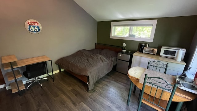 564 66th Rte, Randolph, VT 05060 - bedroom featuring lofted ceiling, wood finished floors, an office area, and freestanding refrigerator