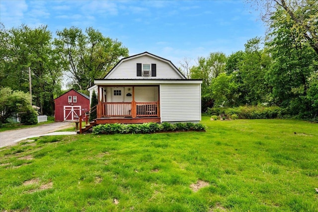 19 Overland St, Laconia, NH 03246 - dutch colonial featuring a porch, a front lawn, and a gambrel roof