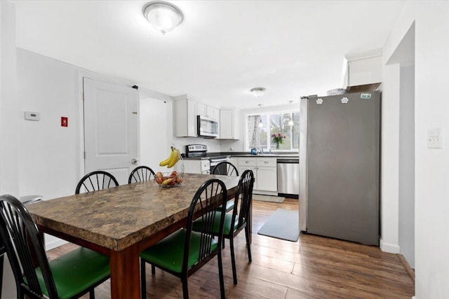 19 Overland St, Laconia, NH 03246 - dining area with wood finished floors and baseboards