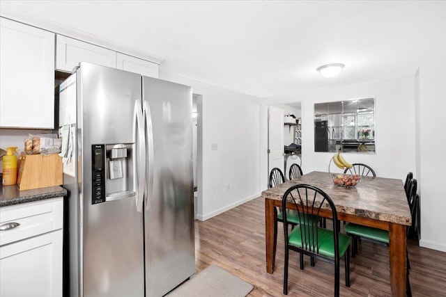 19 Overland St, Laconia, NH 03246 - dining space featuring light wood-style flooring and baseboards