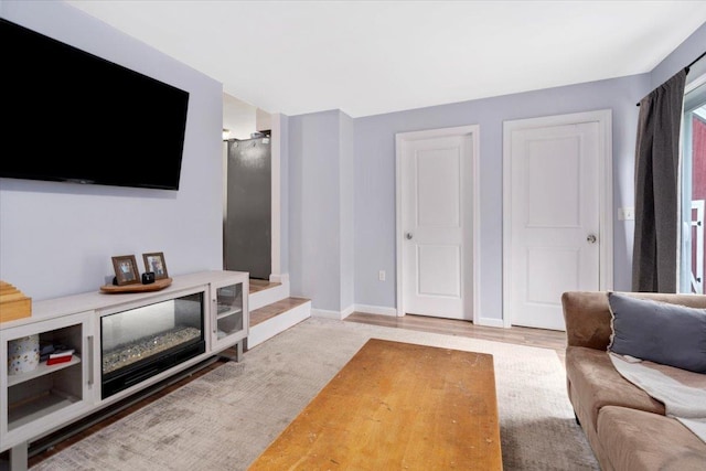 19 Overland St, Laconia, NH 03246 - living area with baseboards and wood finished floors