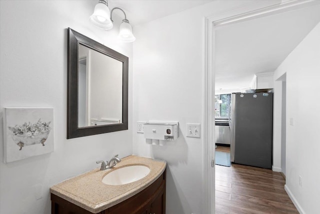 19 Overland St, Laconia, NH 03246 - bathroom with vanity, wood finished floors, and baseboards