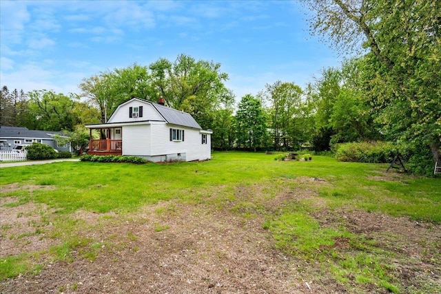 19 Overland St, Laconia, NH 03246 - view of green lawn with a deck and view of wooded area