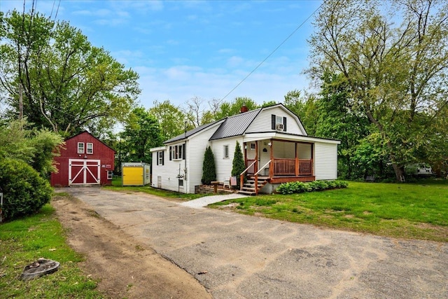 19 Overland St, Laconia, NH 03246 - dutch colonial with a barn, a gambrel roof, a chimney, an outdoor structure, and a front yard