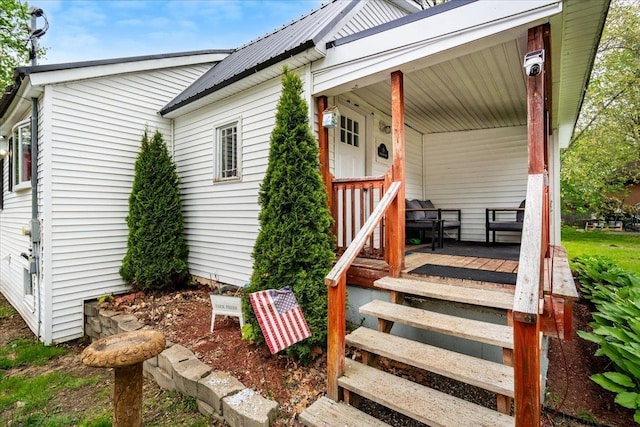 19 Overland St, Laconia, NH 03246 - view of exterior entry with metal roof and a porch