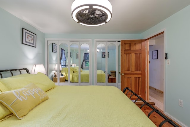 110 Nh Dr, Webster, NH 03303 - bedroom featuring two closets, wood finished floors, and baseboards