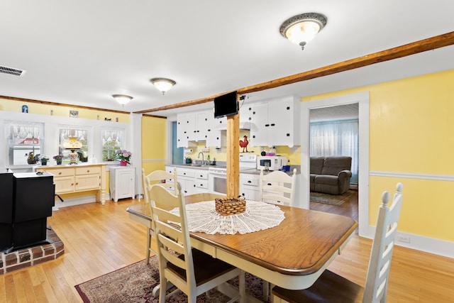 166 New Boston Rd, Goffstown, NH 03045 - dining area featuring light wood-style flooring, healthy amount of natural light, and a baseboard radiator