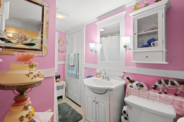 166 New Boston Rd, Goffstown, NH 03045 - bathroom with toilet, vanity, ornamental molding, and tile patterned flooring