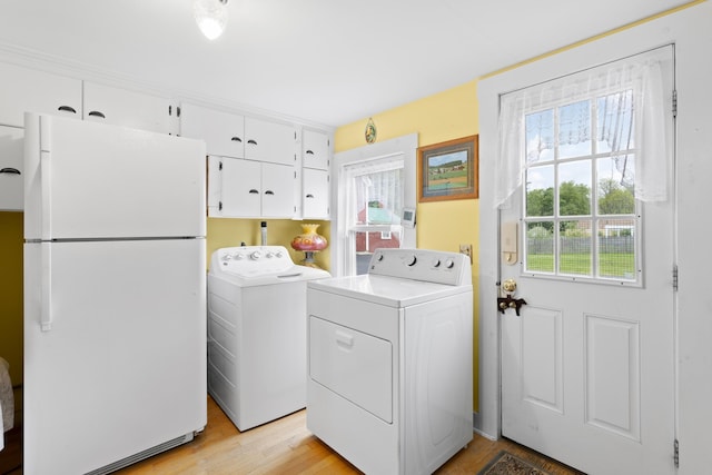 166 New Boston Rd, Goffstown, NH 03045 - washroom with washer and dryer, cabinet space, and light wood-style floors