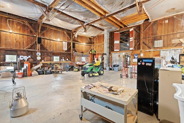 166 New Boston Rd, Goffstown, NH 03045 - misc room featuring wooden walls, concrete flooring, and a garage
