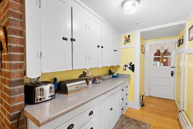 166 New Boston Rd, Goffstown, NH 03045 - kitchen with baseboard heating, light wood-style floors, white cabinets, and light countertops