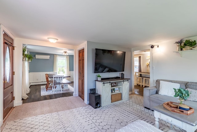 129 Indigo Hill Rd, Somersworth, NH 03878 - living room with a wall mounted air conditioner, wood finished floors, and wainscoting