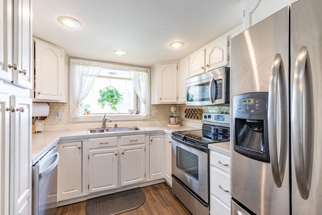 129 Indigo Hill Rd, Somersworth, NH 03878 - kitchen featuring appliances with stainless steel finishes, a sink, white cabinetry, decorative backsplash, and recessed lighting