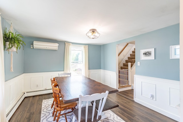 129 Indigo Hill Rd, Somersworth, NH 03878 - dining room featuring a wall unit AC, a baseboard heating unit, wainscoting, dark wood-style floors, and stairway