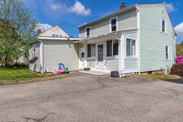 129 Indigo Hill Rd, Somersworth, NH 03878 - view of front of house with a chimney and central air condition unit