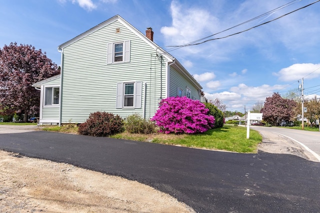 129 Indigo Hill Rd, Somersworth, NH 03878 - view of side of property featuring a chimney