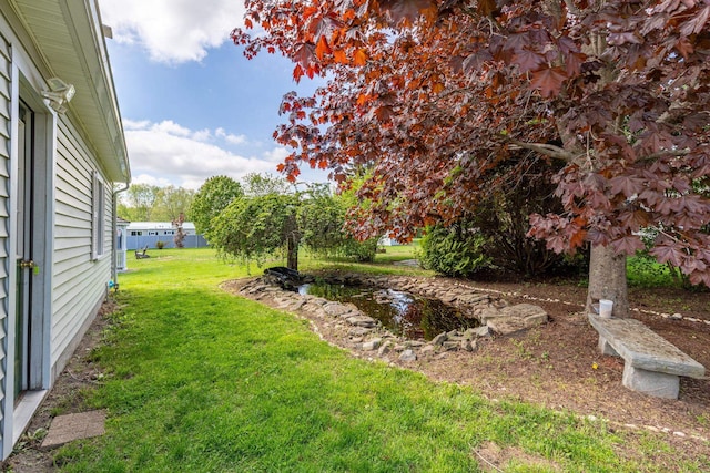 129 Indigo Hill Rd, Somersworth, NH 03878 - view of grassy yard with a garden pond