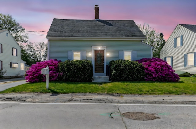 129 Indigo Hill Rd, Somersworth, NH 03878 - cape cod home with entry steps, a chimney, a yard, and roof with shingles