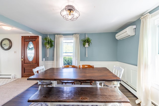 129 Indigo Hill Rd, Somersworth, NH 03878 - dining space featuring a wall unit AC, a baseboard heating unit, dark wood-style flooring, wainscoting, and a decorative wall