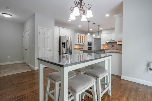 35 Northland Rd, Windham, NH 03087 - kitchen with appliances with stainless steel finishes, a kitchen island, a chandelier, white cabinets, and recessed lighting