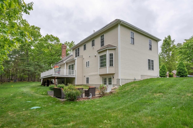35 Northland Rd, Windham, NH 03087 - back of house with a chimney, a lawn, a wooden deck, and french doors