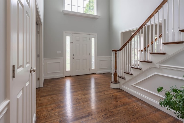 35 Northland Rd, Windham, NH 03087 - entrance foyer with a decorative wall, a high ceiling, wainscoting, stairs, and wood finished floors
