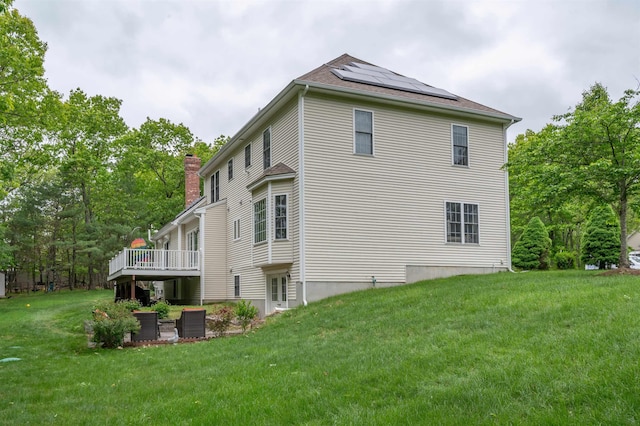 35 Northland Rd, Windham, NH 03087 - view of property exterior with solar panels, a lawn, a chimney, and a wooden deck