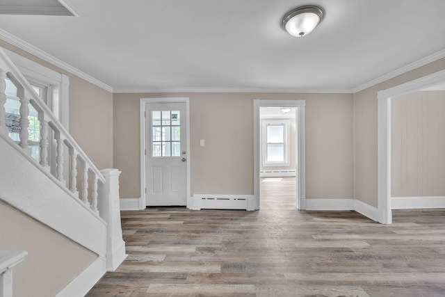 149 Pearl St, Saint Albans City, VT 05478 - foyer entrance with baseboard heating, wood finished floors, baseboards, and ornamental molding