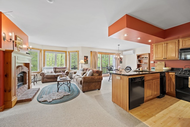 143 Bridge Rd Unit Vc331, Jay, VT 05859 - kitchen featuring black appliances, an AC wall unit, a sink, a peninsula, and open floor plan