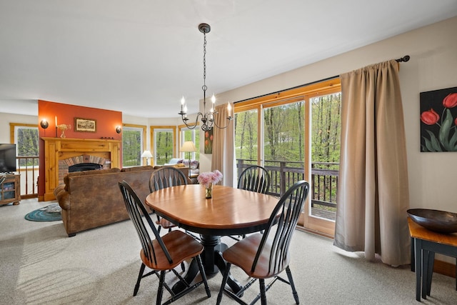 143 Bridge Rd Unit Vc331, Jay, VT 05859 - carpeted dining room featuring a chandelier and a fireplace