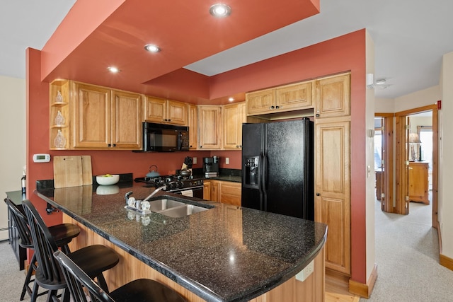 143 Bridge Rd Unit Vc331, Jay, VT 05859 - kitchen featuring black appliances, a peninsula, light colored carpet, recessed lighting, and a breakfast bar