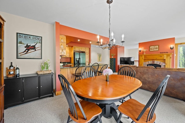 143 Bridge Rd Unit Vc331, Jay, VT 05859 - dining space with a fireplace, a chandelier, and light colored carpet