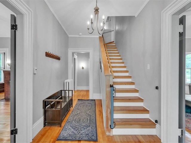 65 Congress St, Saint Albans City, VT 05478 - stairs with wood finished floors, ornamental molding, a chandelier, baseboards, and radiator heating unit