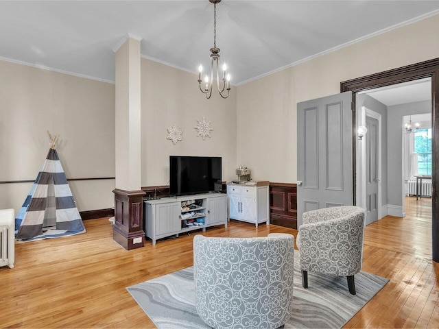 65 Congress St, Saint Albans City, VT 05478 - living area with a chandelier, light wood-style flooring, crown molding, radiator, and baseboards