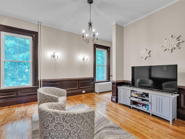 65 Congress St, Saint Albans City, VT 05478 - living room with radiator, light wood-type flooring, a chandelier, plenty of natural light, and crown molding